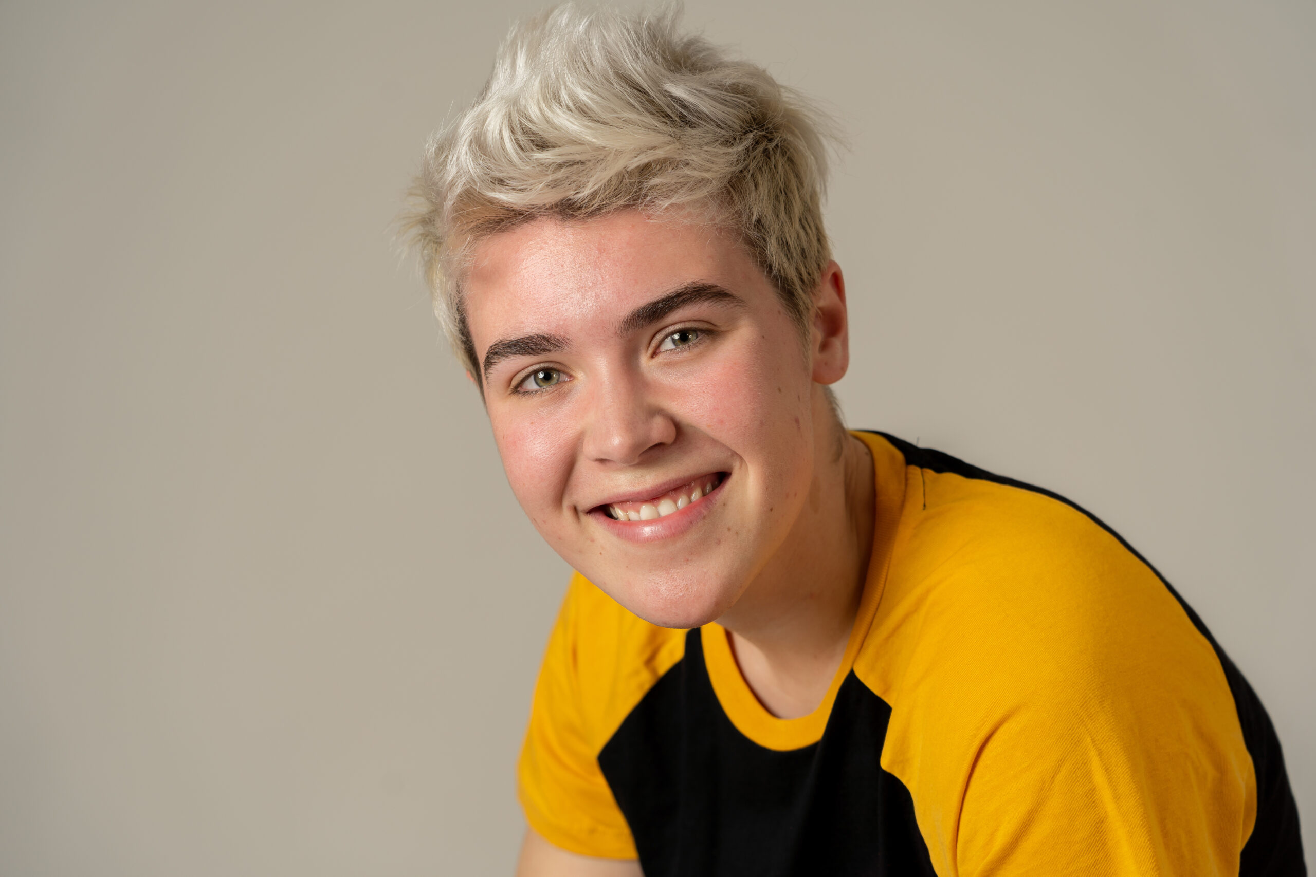 Portrait of young attractive stylish fashion teenager confident and happy with his gender identity. Trans boy posing in cool urban fashion t shirt. In Beauty, Transgender people and Equality concept.