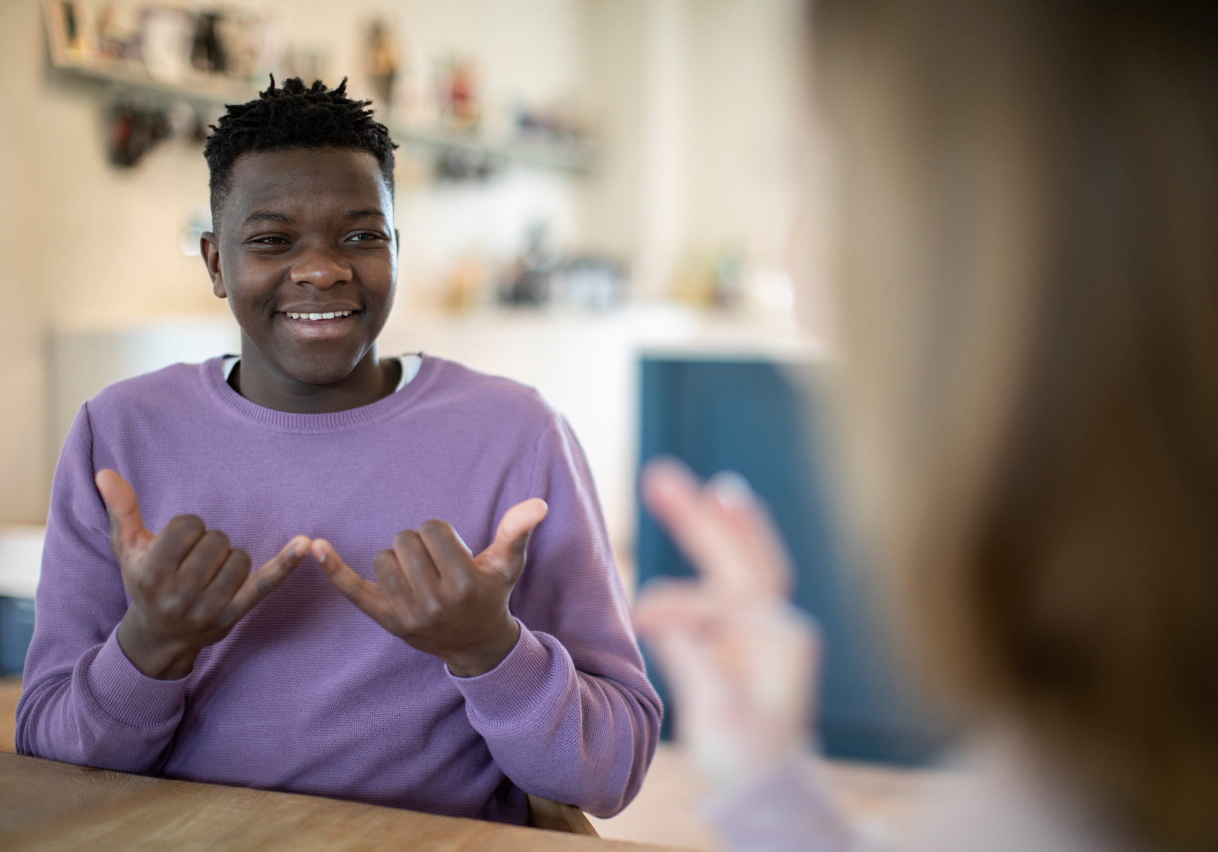 Teenage Boy And Girl Having Conversation Using Sign Language